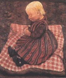 Kind auf rotgewürfeltem Kissen